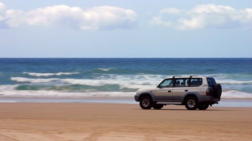 SUV moving on the beach 